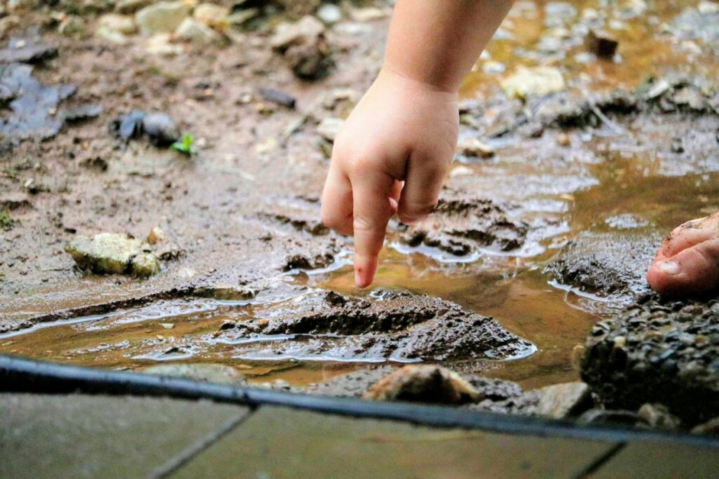 "Child's hands shaping clay - natural regulation for the overstimulated child"